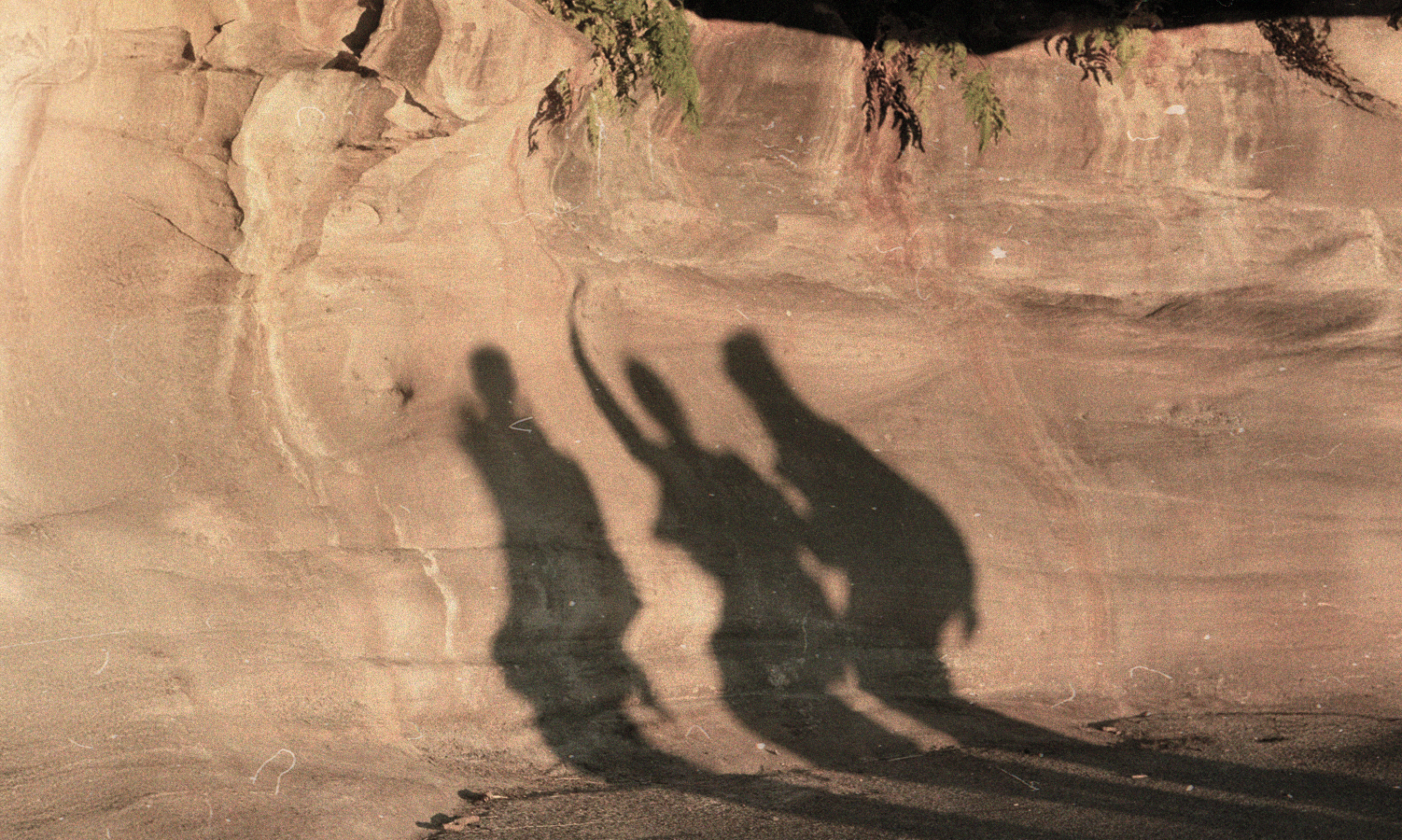 Shadows of three men on a journey 