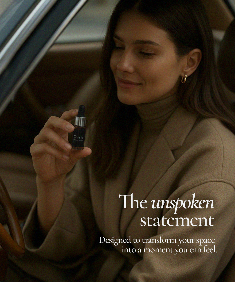 Woman holding O'sric scented essence oil bottle inside a car 